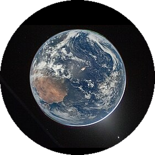 Earth photographed from the Artemis II spacecraft, 2023. Australia and the Pacific Ocean are visible at centre-left, with a bright atmospheric glow along the limb and the Moon visible in the lower right. Credit: NASA, Public Domain.